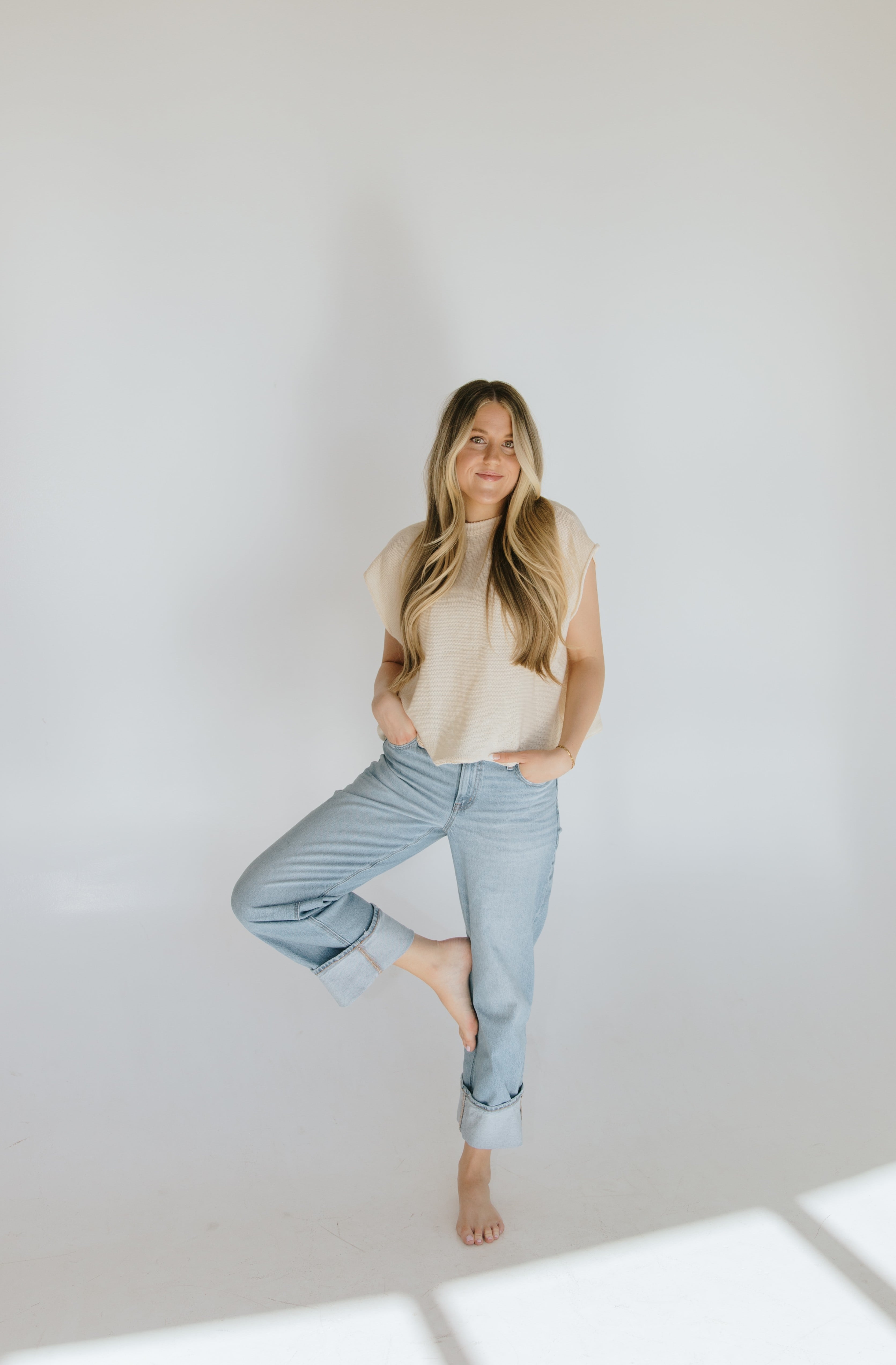 Founder seated in a light studio with soft natural light.